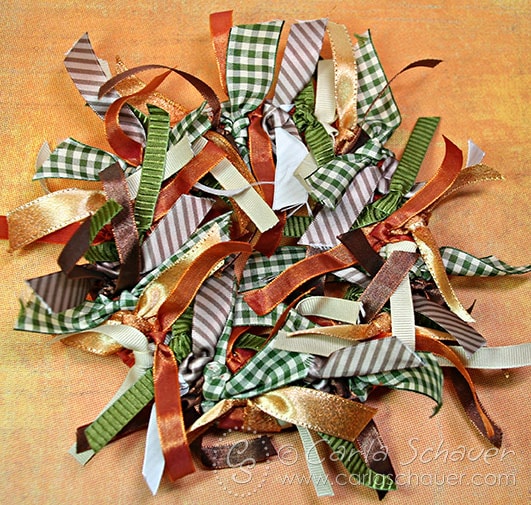 A mix of autumn ribbons tied in a circle to make a fall wreath.