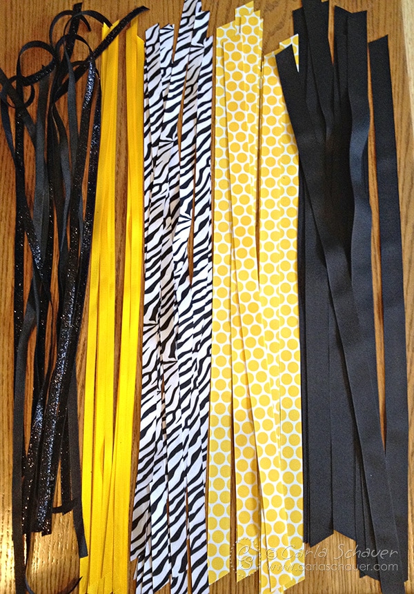 Vertical yellow, black and white ribbons arranged to make bulk athletic bows.