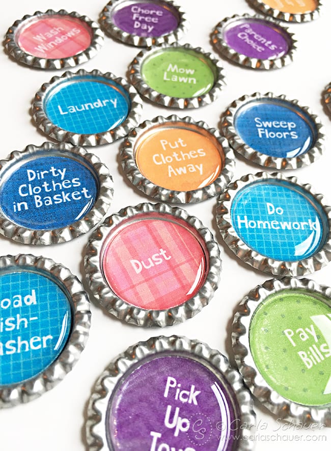 colorful patterned circles with white text, inside flattened silver bottlecaps.