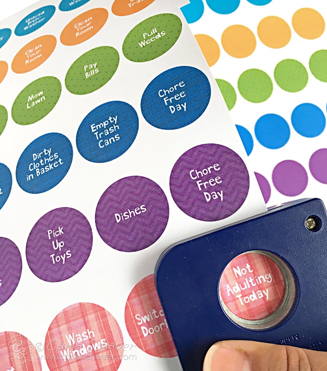 blue paper punch punching colorful patterned circles from white paper.