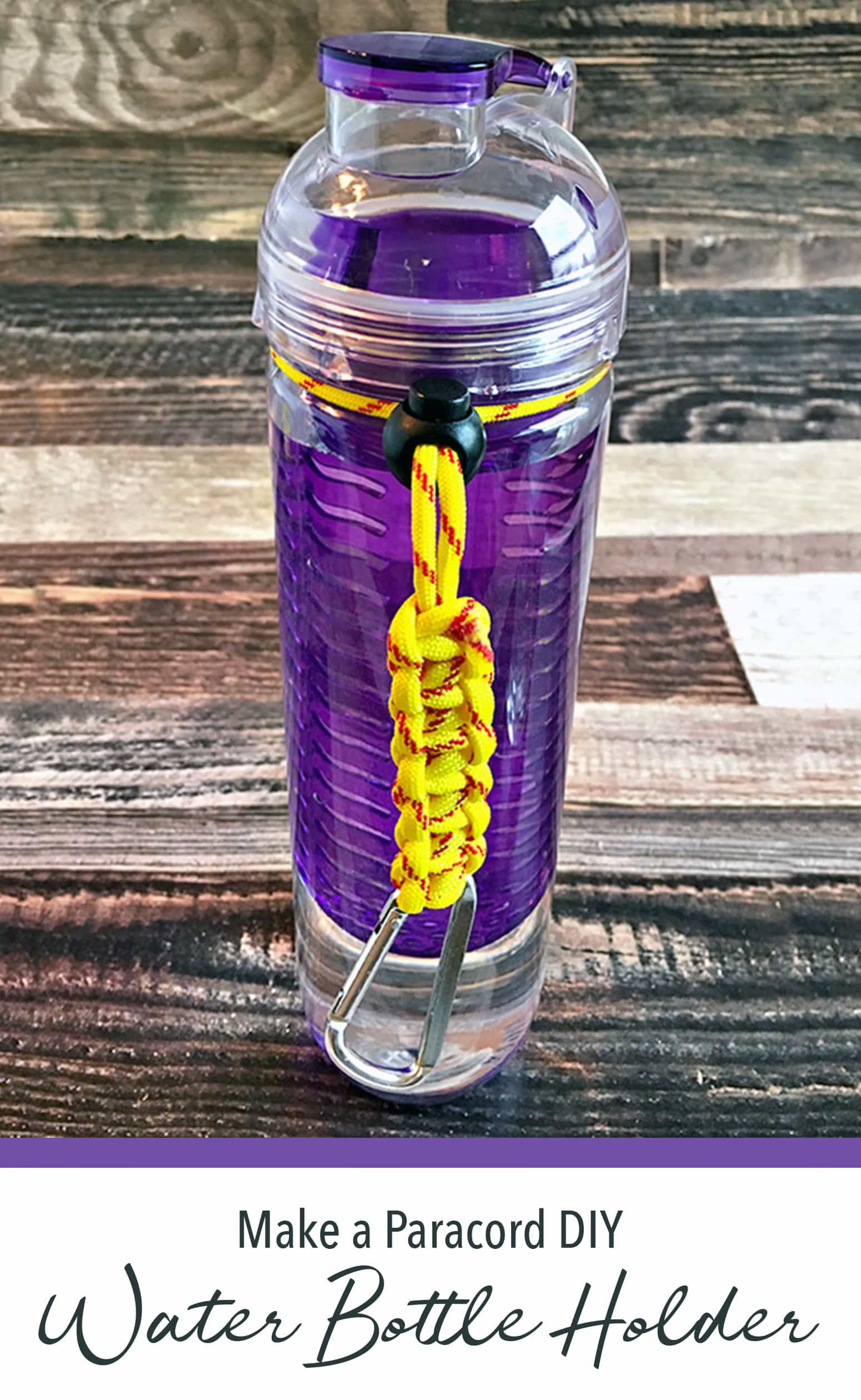 Yellow paracord bottle holder attached to purple reusable bottle, on wood table.