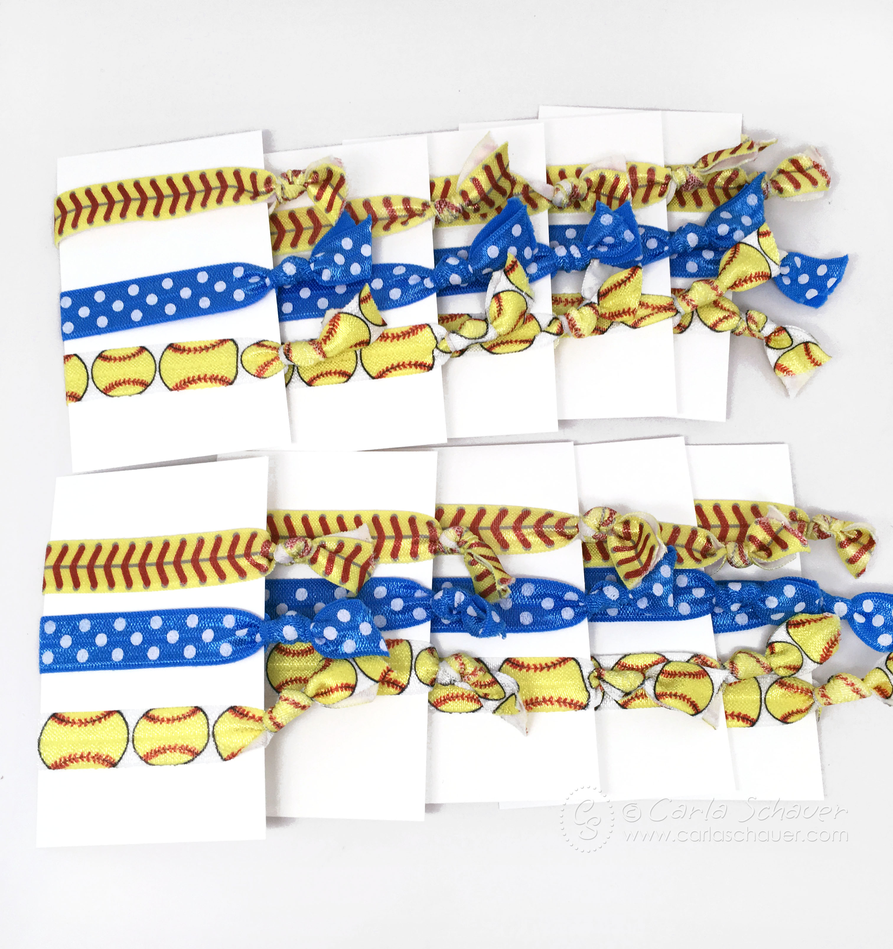 Softball-themed elastic no-crease hair ties,displayed on white cards.