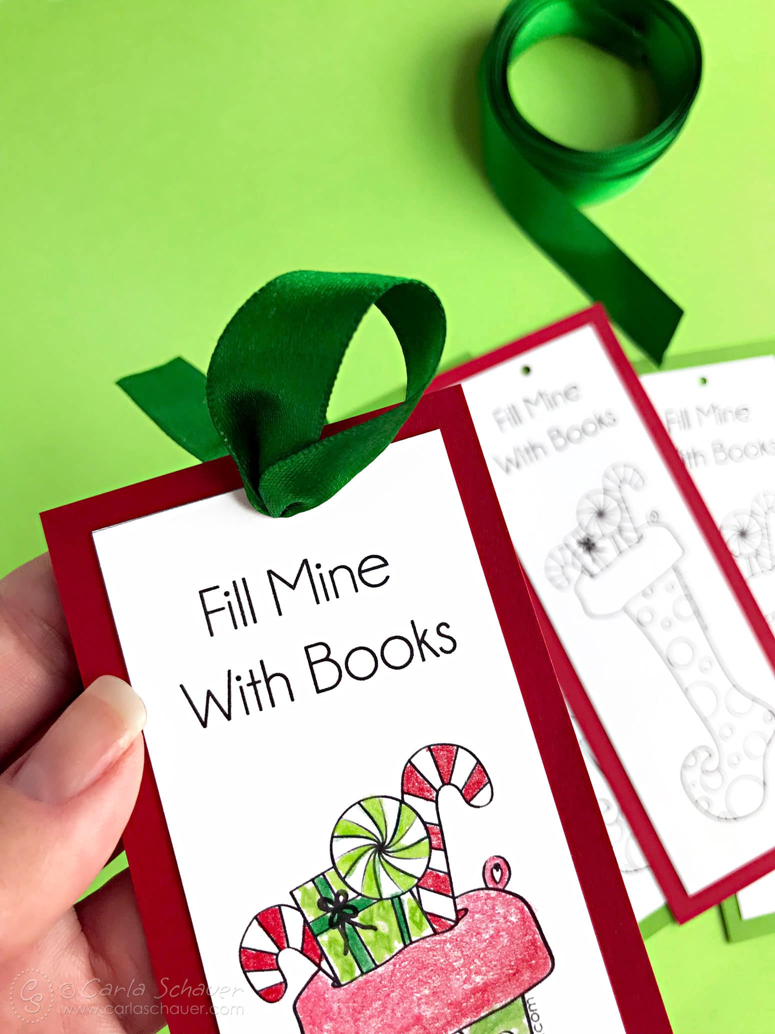 Green ribbon tied to printable Christmas bookmark craft.
