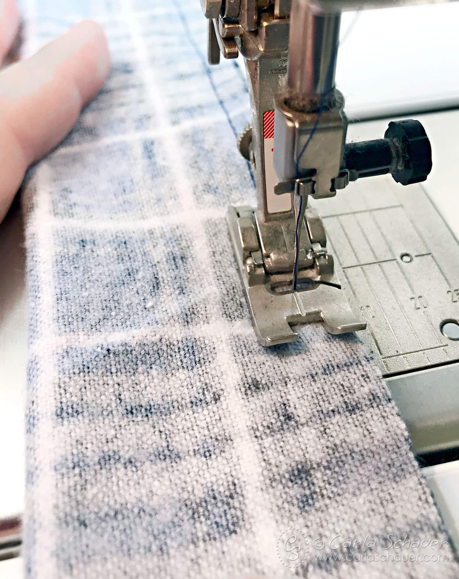 Plaid flannel fabric being sewn.