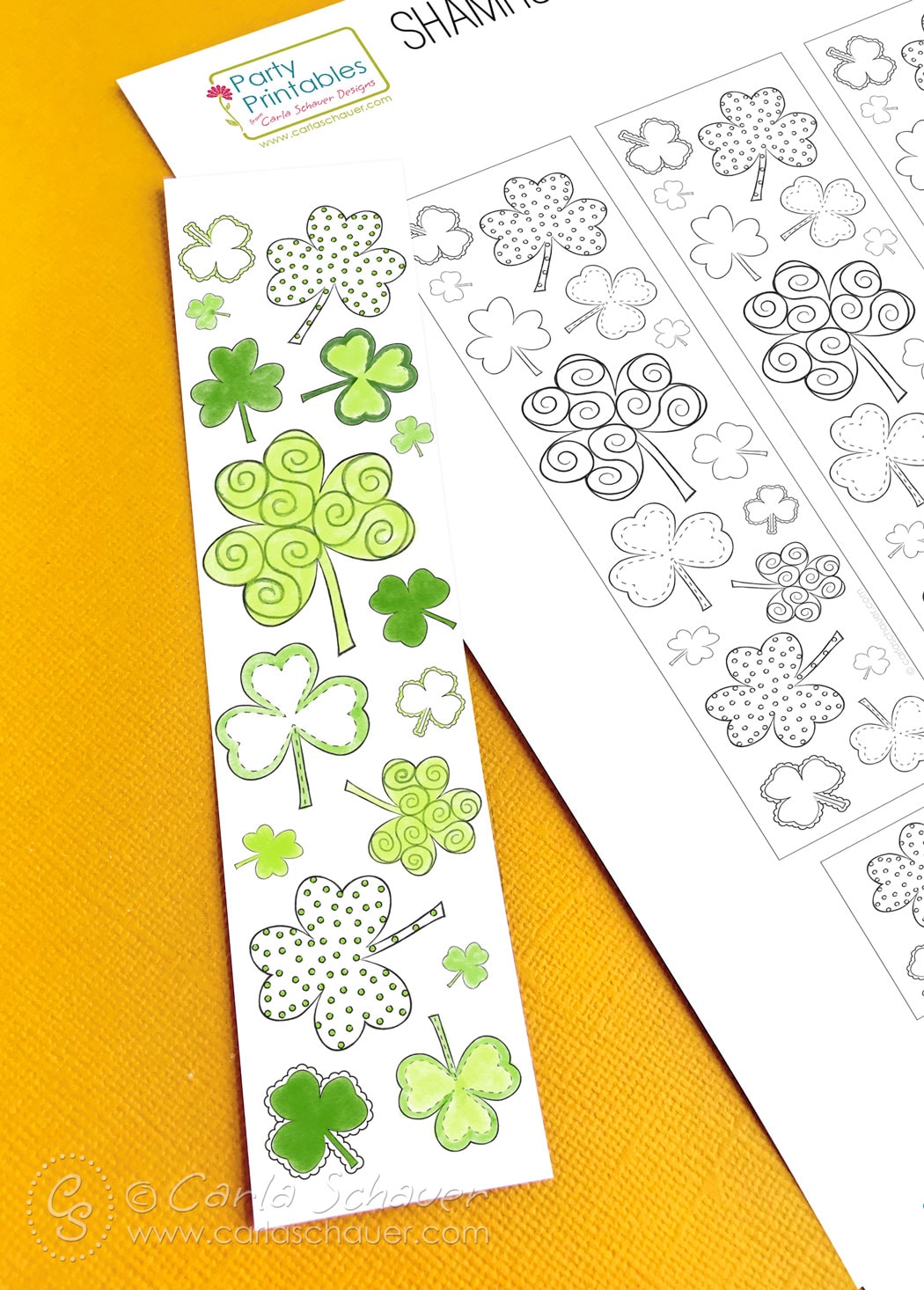 Colored shamrock printable bookmark and sheet on yellow background.