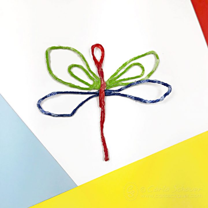 Waxed string dragonfly on colored paper.