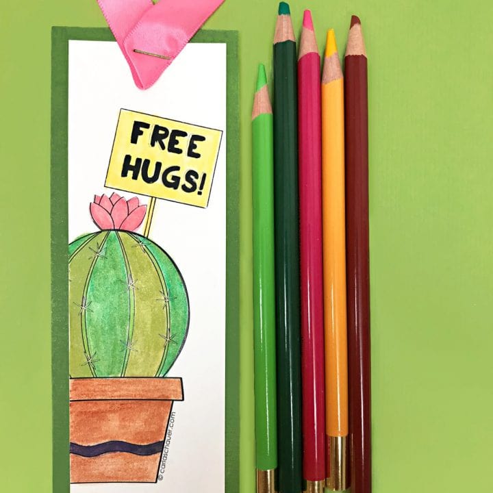 cactus bookmark and colored pencils on green background
