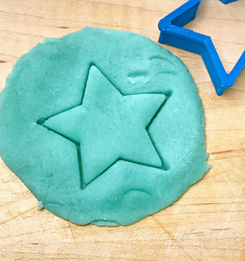 Cutting star shape from DIY Playdough.