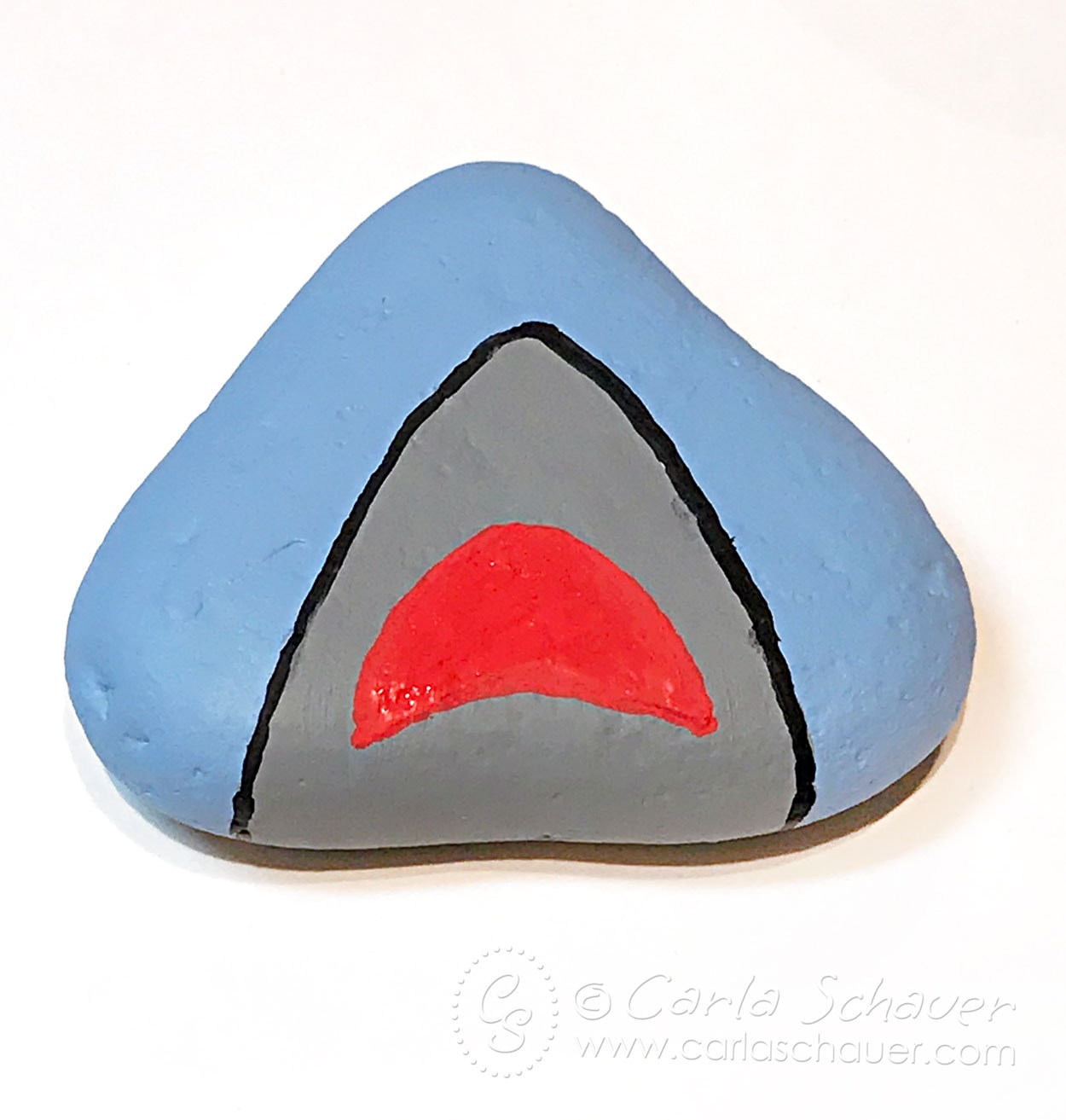 Painted shark mouth on blue triangle rock.