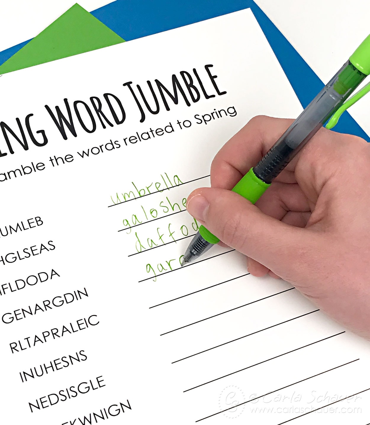 Writing words on spring word puzzle with green pen