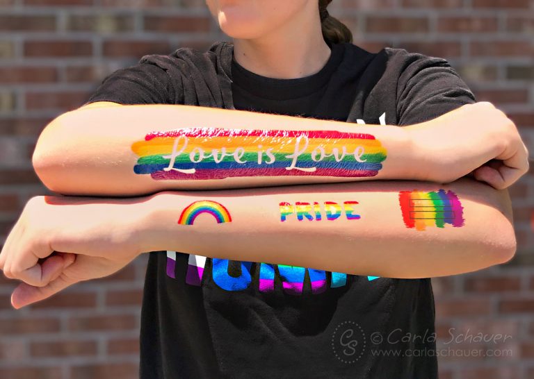 Pride Rainbow Tattoos on crossed arms