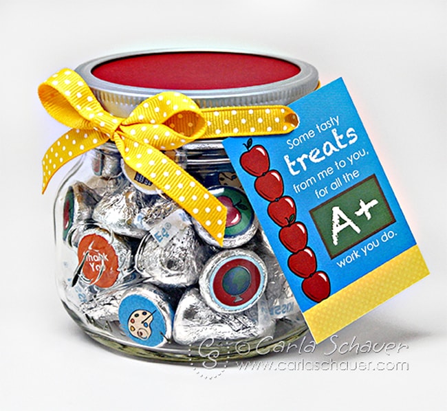 Jar of chocolate kisses decorated with school themed printable circles, with red lid, yellow ribbon, and printable tag.