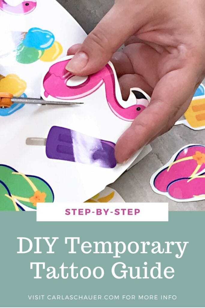 hand cutting out flamingo temporary tattoo from sheet with scissors. White text overlay over green bar reads "DIY Temporary Tattoo Guide"