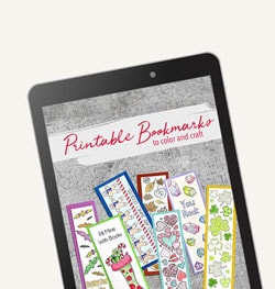 printed, colored bookmarks on cement background, on an ipad screen