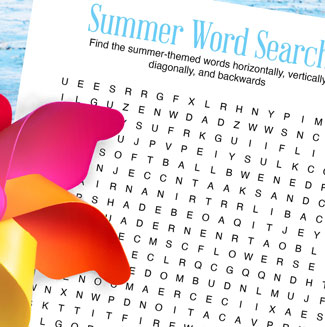printed summer word search on white paper, placed on a blue background with bright pinwheel on top