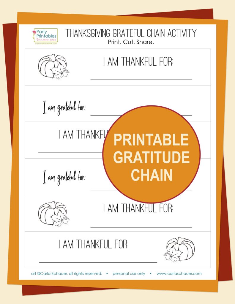 Printed white cardstock page with strips. Each strip has a pumpkin image and text that reads "I am thankful/grateful for." Page is stacked on orange and cranberry paper, an orange circle with cream text reading "Printable Gratitude Chain" is on top of stack.