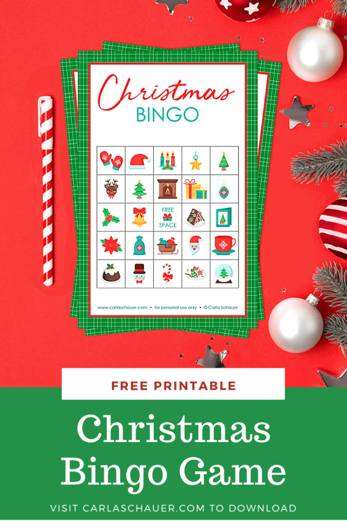 Stack of 3 Christmas bingo cards with a 5x5 grid of festive Christmas icons and a green border. Bingo cards are lying on a red background, next to red, white, and green decorations and a red and white striped pen. Below the picture is a green rectangle with white text that reads "Christmas Bingo Game, visit carlaschauer.com to download."