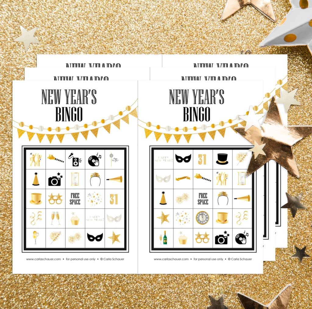 3 pages of New Year's Bingo cards printed 2 per page on white paper, lying stacked on a gold glitter background with shiny gold stars. Each bingo sheet has a 5x5 grid of party icons, a gold pennant banner, and black text that reads "New Year's BINGO"