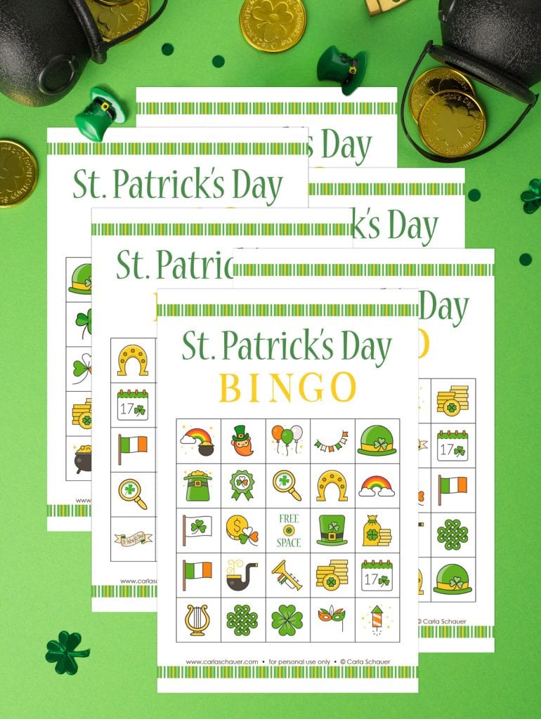 6 St. Patrick's Day Bingo cards printed on white paper, with green and gold decorative stripes on each. Cards are overlapped on a green background with gold coins and green confetti.